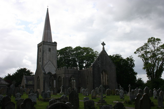 Holy Trinity Parish Church in Buckfastleigh, showing the rebuilt spire in the wider churchyard setting.
